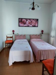two beds sitting next to each other in a room at Villino Giuliana in Pietrasanta +18 photos