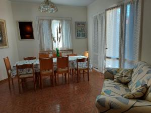 a living room with a table and chairs and a couch at Villino Giuliana in Pietrasanta