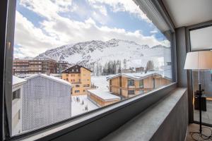 a window with a view of a snowy mountain at Litzi Heidi in Arosa