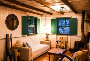 a living room with a couch and a table at Chalé Memórias 1945, Cascata do Caracol, Canela-RS in Canela