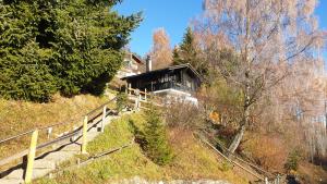 una casa en una colina con escaleras que conducen a ella en Charming chalet with panoramic view and private garage in Gruyère en Gruyères