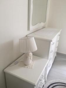 a white desk with a lamp on top of it at Apartament Oresti in Korçë