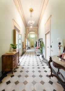 a large hallway with a checkerboard floor at Palazzo D'Ambra Residenza d'Epoca in Florence