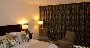Postel nebo postele na pokoji v ubytování New Brookfields Hotel
