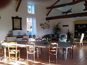 a dining room with a table and chairs at La Marsaisienne in Marsais