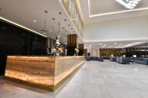 a lobby with a reception desk in a building at JUFFAIR BOULEVARD HOTEL & SUITES in Juffair