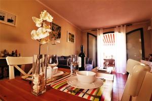 a dining room with a table with a vase of flowers at Apartment with large relax terrace and top equipment in Costa Del Silencio