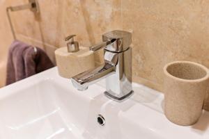 a bathroom sink with a chrome faucet on it at Cuddfan Lodge on a Gorgeous Private Lake in Newport