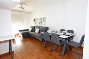 a living room with a table and a couch at Alojamientos Libertad in Yecla