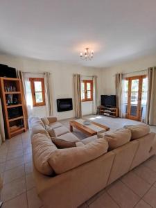 a large living room with a large couch at Unique Stonehouse Traditional Villa in Ayia Anna in Ayia Anna