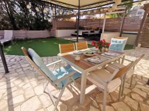 a dining table and chairs on a patio at Unique Stonehouse Traditional Villa in Ayia Anna in Ayia Anna