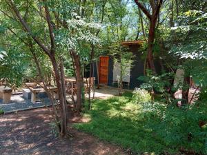 a cabin in the woods with a picnic table and trees at Vulture's View 1 in Hartbeespoort