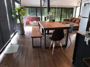 a living room with a table and a couch at The Balcony pool villa in Ban Khanong Phra Nua