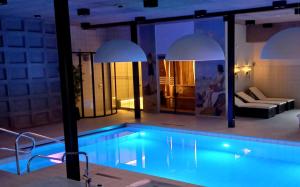 a swimming pool in a room with a house at Hotel 1622 - Spa, Hotell & Konferens in Helsingborg