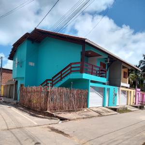 una casa blu sul lato di una strada di Casa Carvalho Milagres a São Miguel dos Milagres