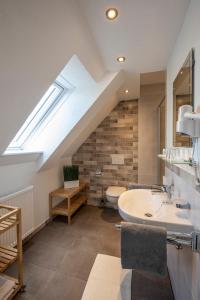 a bathroom with a sink and a skylight at Landgasthof zur Sonne in Dillingen an der Donau