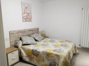 a bedroom with a bed and a picture on the wall at Casa Carmen 2 in Cudillero