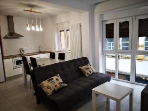 a living room with a couch and a kitchen at Casa Carmen 2 in Cudillero