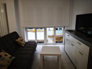 a living room with a couch and a coffee table at Casa Carmen 2 in Cudillero