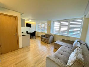 a living room with a couch and a table at Central Apartment in Palanga