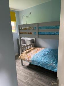 a bedroom with a bed and a bunk bed at JJs Lodge Holiday Home Bude in Kilkhampton