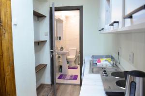 a bathroom with a sink and a toilet at Private Apartment in the City Centre. in Oradea +19 photos