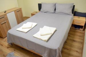 a bed with two towels on top of it at Private Apartment in the City Centre. in Oradea