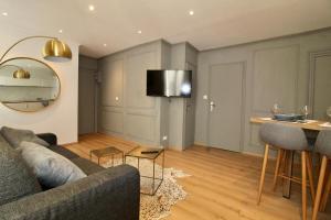 uma sala de estar com um sofá e uma mesa em Lovely Apartment Heart of Golden Square Fiber Wifi em Nice