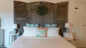 a bedroom with a bed with a wooden headboard at La Grange de Gournay in  Gournay-Loizé +37 photos