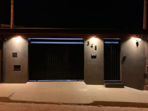 a building with two doors with a clock on it at Casa de Temporada do Spa in Olímpia