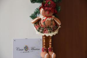 a teddy bear ornament hanging from a christmas tree at Casa Marino in Sorrento