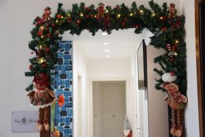 a christmas wreath on a doorway with christmas decorations at Casa Marino in Sorrento
