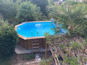 een uitzicht over het zwembad in de tuin bij chambre privée in Lombron