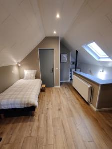 a large bedroom with a bed and a skylight at La fa'Meuse escale in Vireux-Wallerand