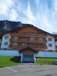 a large building with a balcony on top of it at Le Rhodo in Thollon