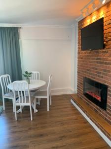 a living room with a table and a fireplace at Apartament Claudia -self check-in in Brăila