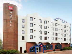 a large brick building with a clock on the side of it at ibis Portsmouth in Portsmouth