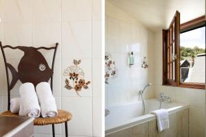 a bathroom with a bath tub and a chair with towels at Hotel Le Dauphin in Honfleur