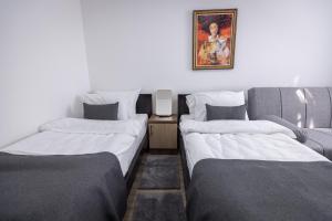 Postel nebo postele na pokoji v ubytování Vila Greta by Hotel Ramonda