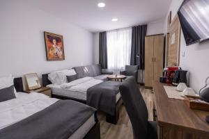 Postel nebo postele na pokoji v ubytování Vila Greta by Hotel Ramonda
