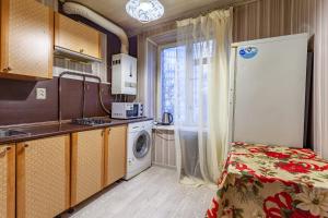 a kitchen with a washer and dryer in a room at Busines Brusnika Apartment Babushkiskaya 1 in Moscow
