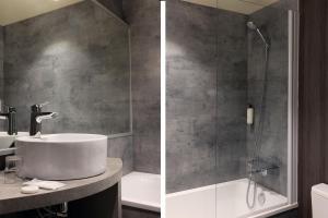 a bathroom with a sink and a shower at Hotel Le Dauphin in Honfleur