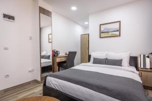 Postel nebo postele na pokoji v ubytování Vila Greta by Hotel Ramonda