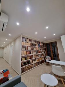 ein Zimmer mit einem großen Bücherregal voller Bücher in der Unterkunft Nonno Umberto Apartments in Pompei