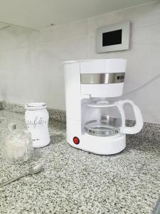 a coffee maker sitting on top of a counter at Departamento céntrico Crespo in Santa Fe +15 photos