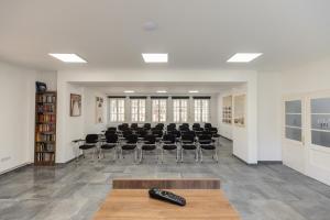 a conference room with chairs and a remote control on a table at Vila Greta by Hotel Ramonda in Rtanj