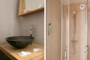 a bathroom with a black sink and a shower at Hotel Le Dauphin in Honfleur