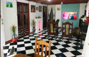 a room with a black and white checkered floor at Typical House Bluefields in Bluefields +37 photos