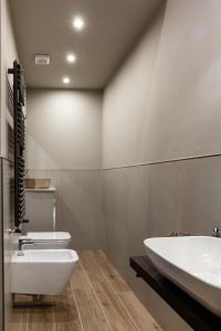 a bathroom with a white toilet and a sink at La casa di Alice in Parma