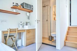a small bathroom with a sink and a toilet at The Amsterdam Houseboat Family - de Pijp in Amsterdam